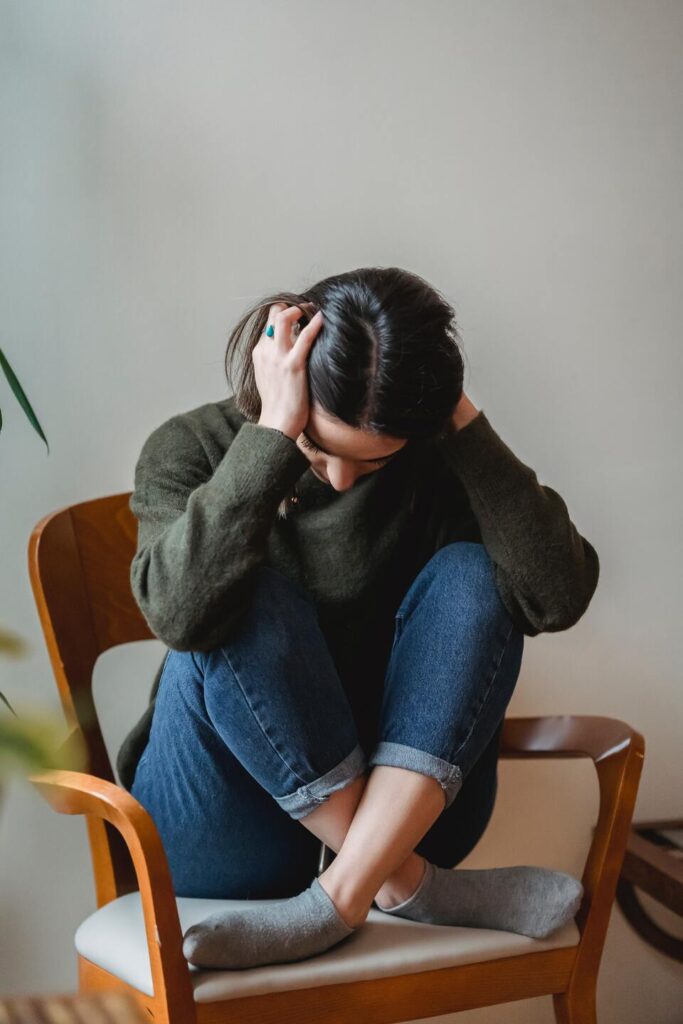 photo anxious female sitting in chair