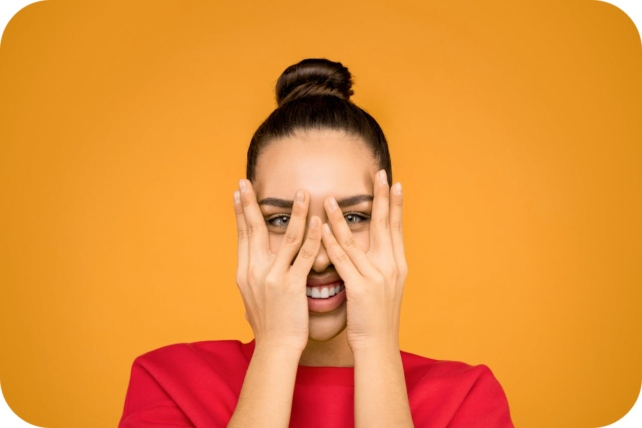 insecure woman with hands over face - how to get over imposter syndrome as a coach