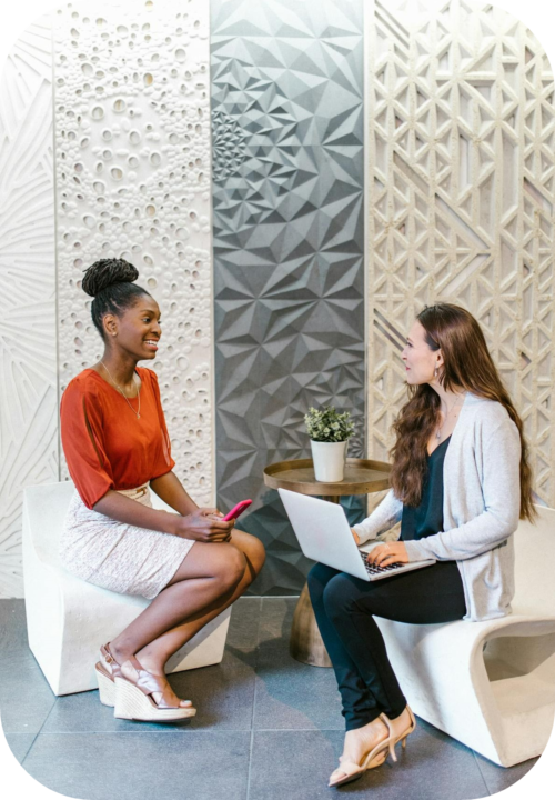 two business women sitting talking