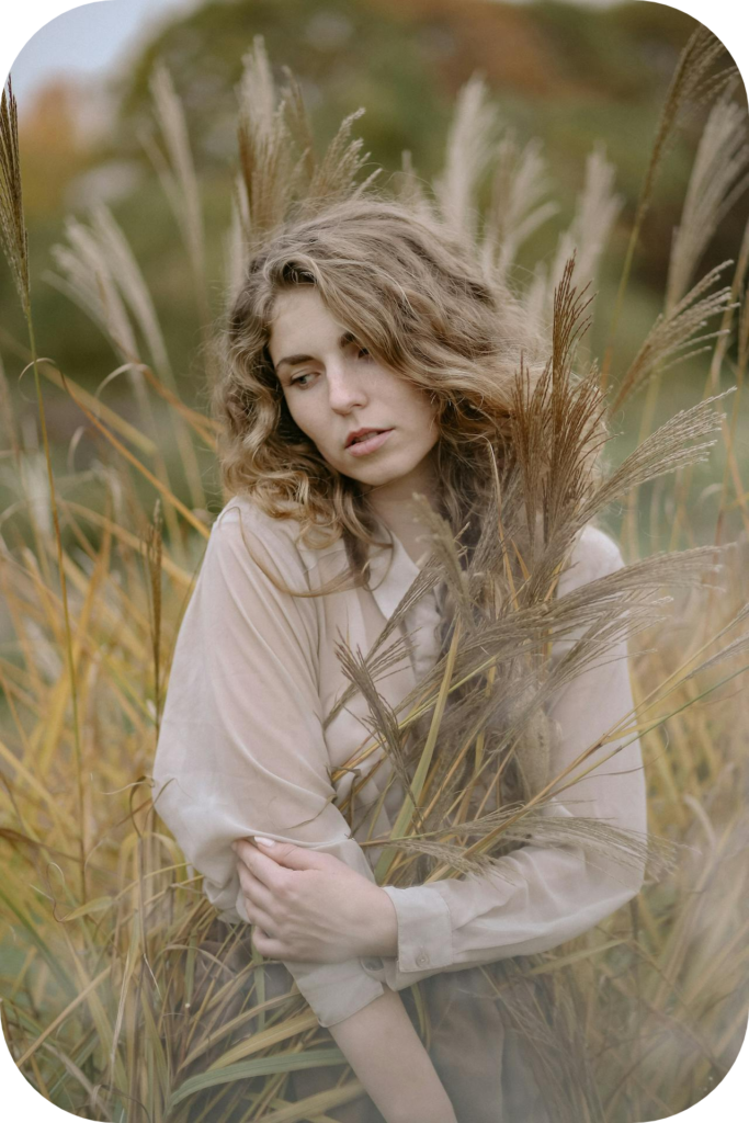 woman lingering in tall bush plants - gaining confidence to become a healer