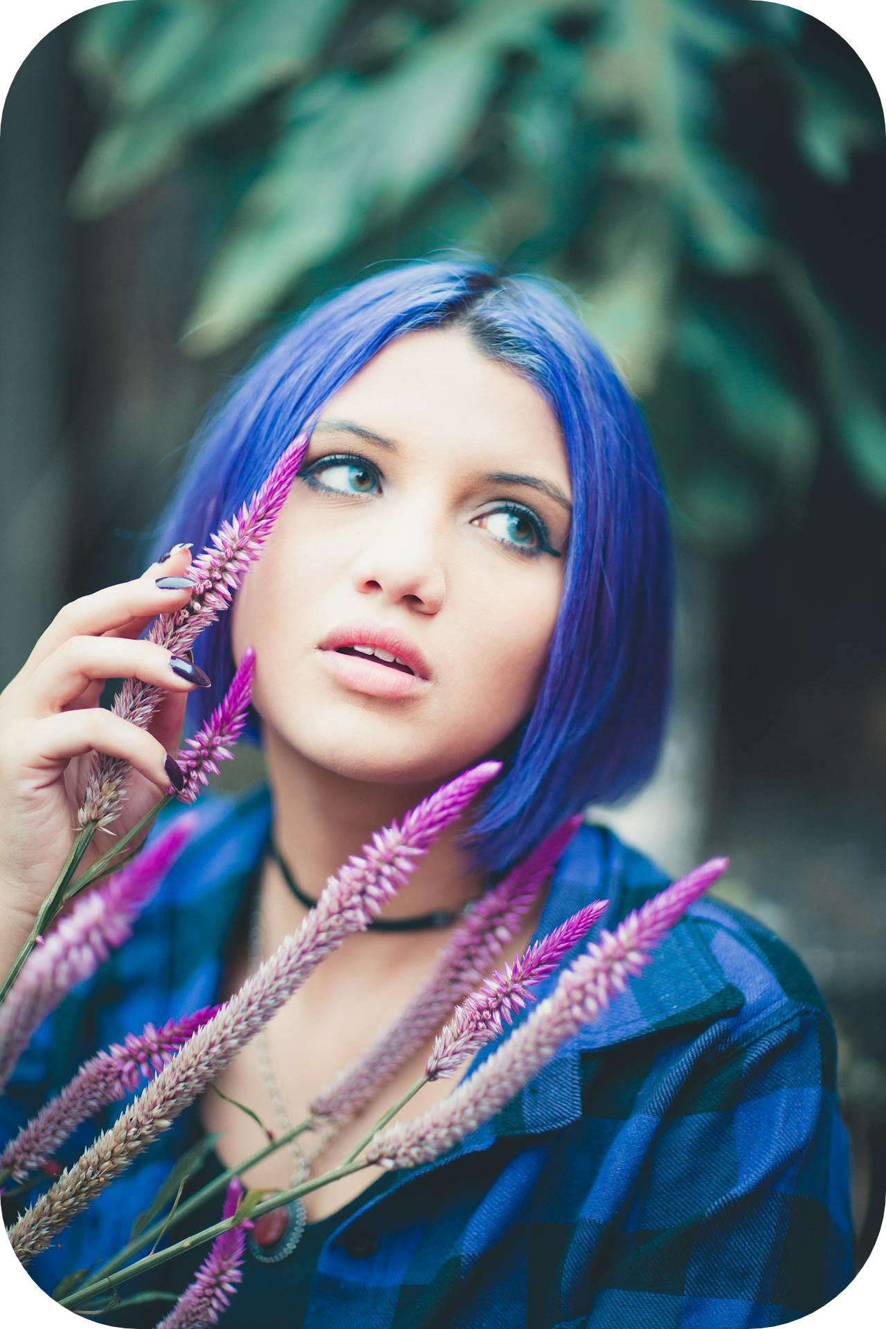 woman with blue hair touching flowers - how to build confidence as a coach