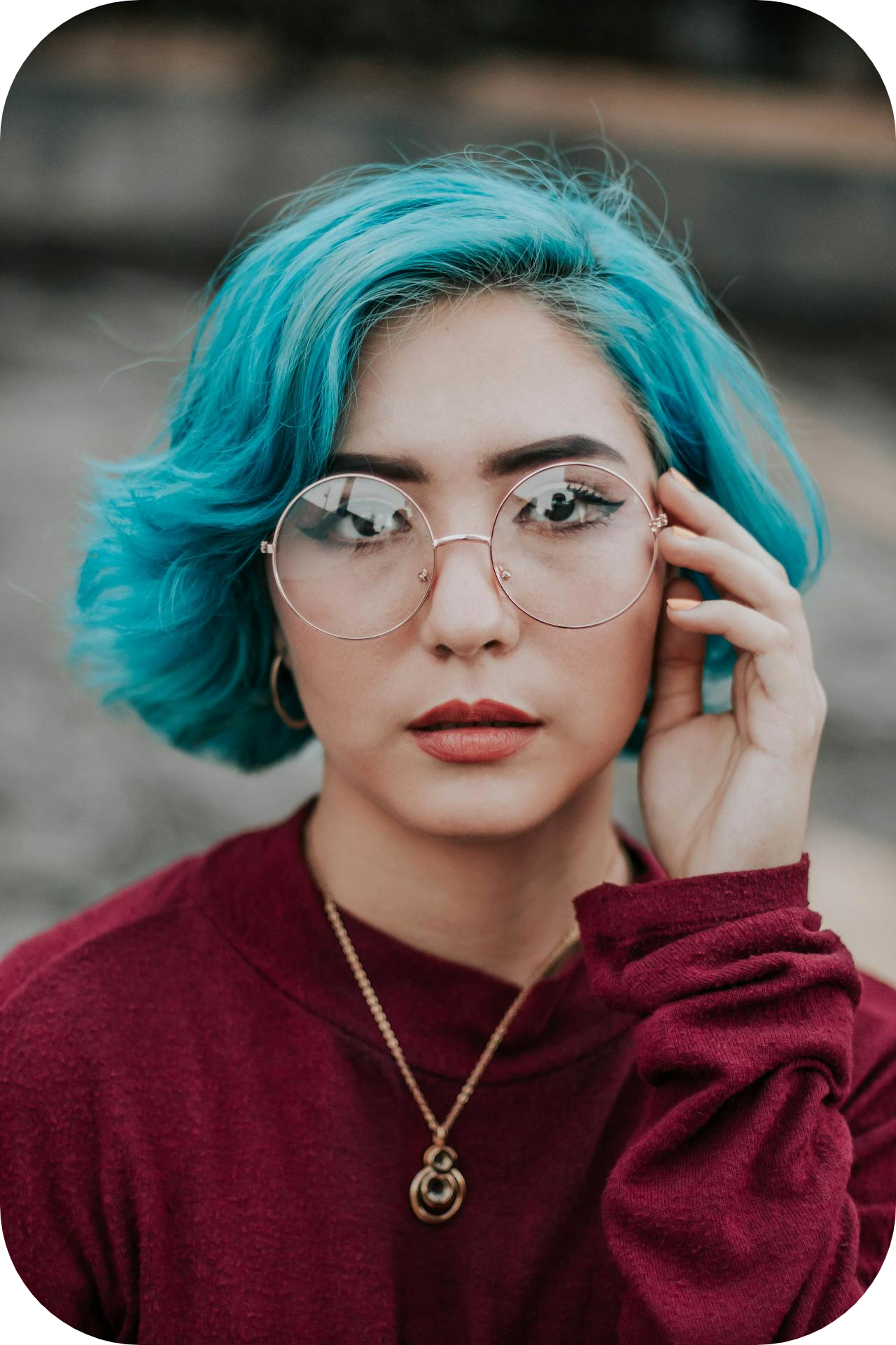 woman with blue hair wearing glasses - build confidence as a coach or healer